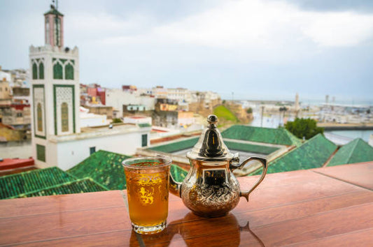A glass of Moroccan mint tea with fresh spearmint leaves and green tea — brewed traditionally