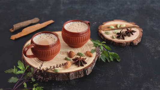 Creamy masala chai latte in a mug with cinnamon and cardamom spices — homemade spiced tea latte
